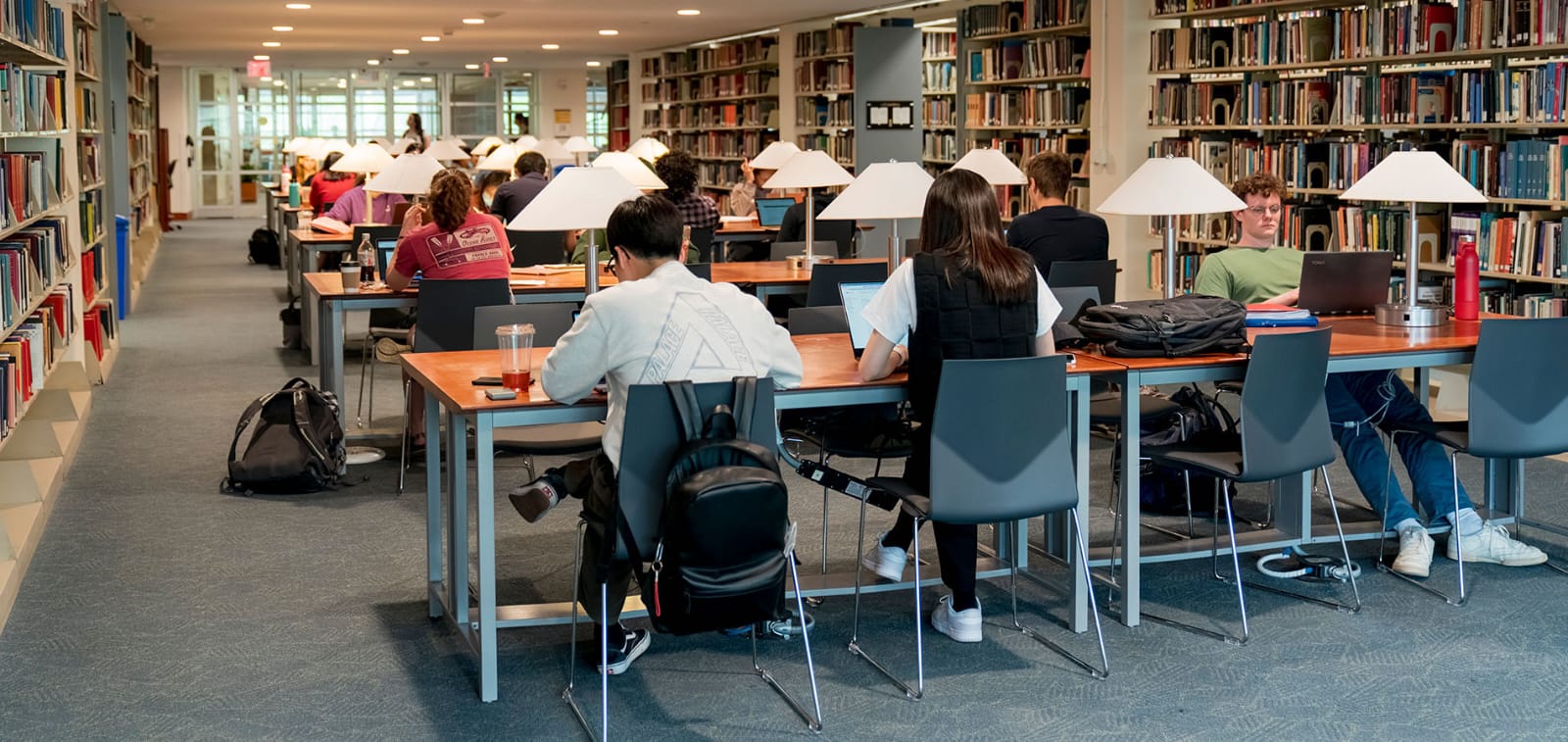 A university library at full capacity, every seat taken.